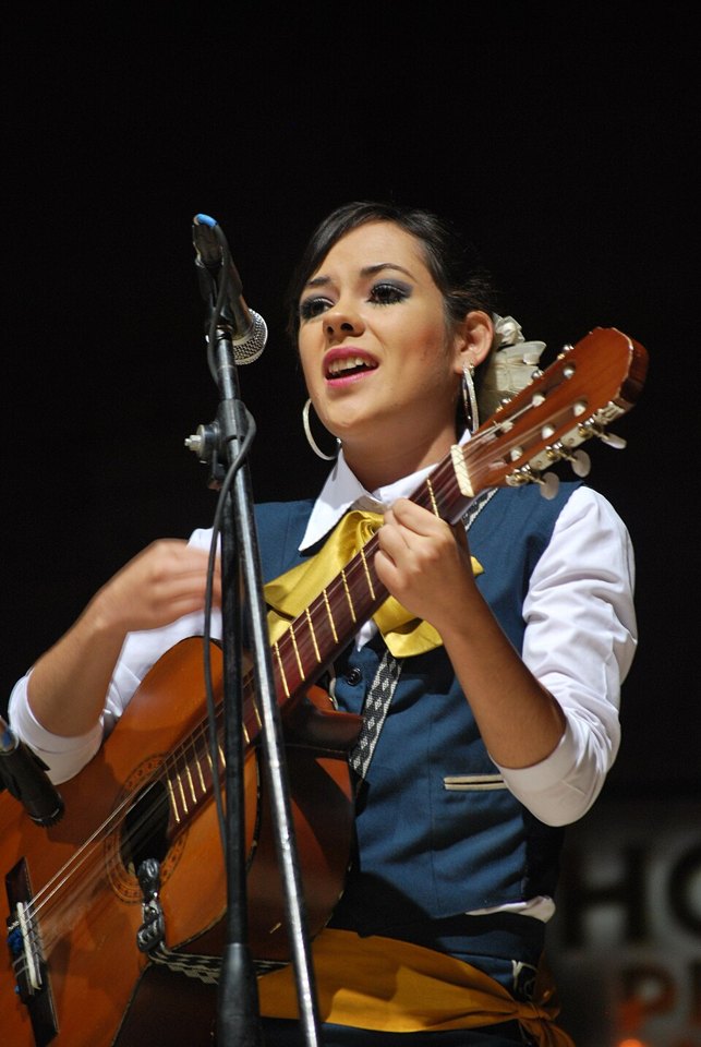 Mariachi performer playing a guitar