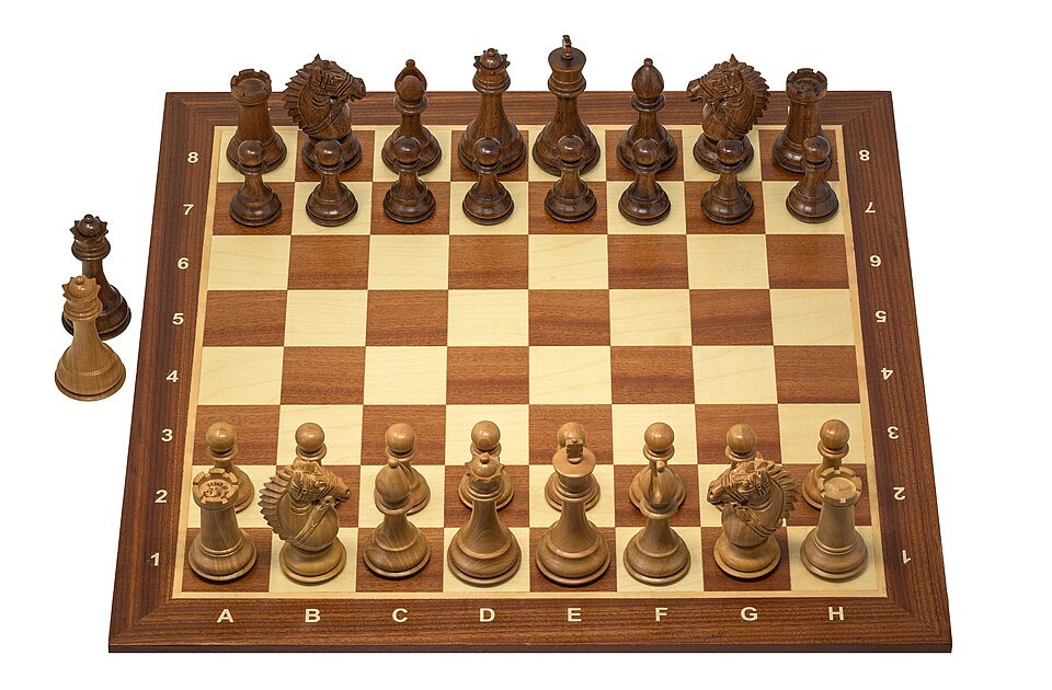 Wooden chess pieces arranged on a chessboard