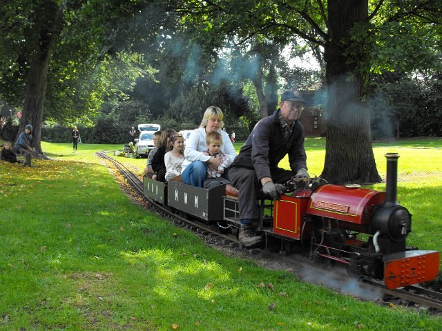 A miniature train at an outdoor ride