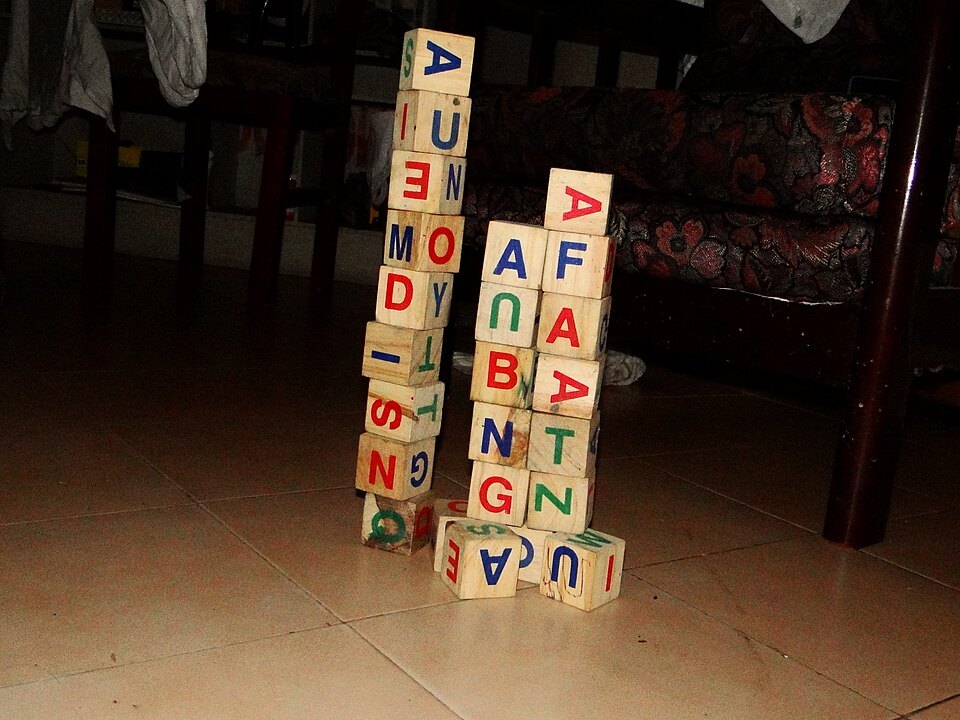 Wooden alphabet blocks stacked into towers